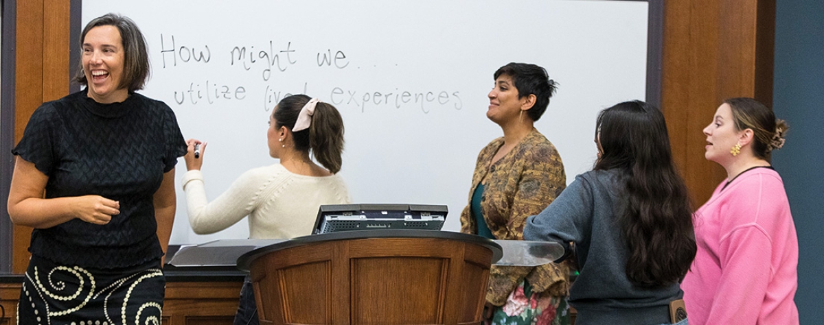 Professor Bridgette Carr teaching students in a classroom.